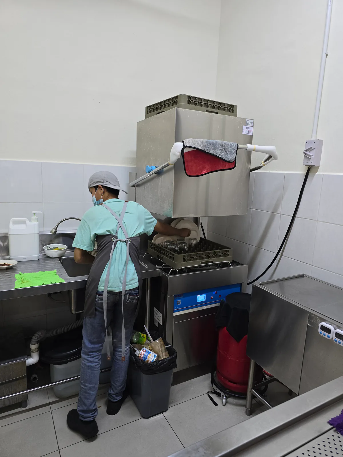 Staff using clean water to wash dishes.