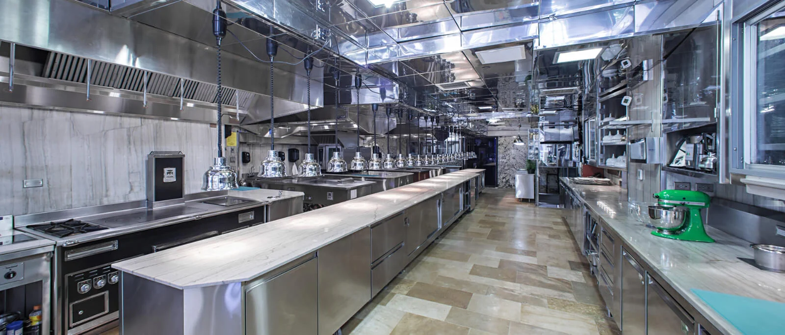 Commercial kitchen interior with stainless steel preparation counters